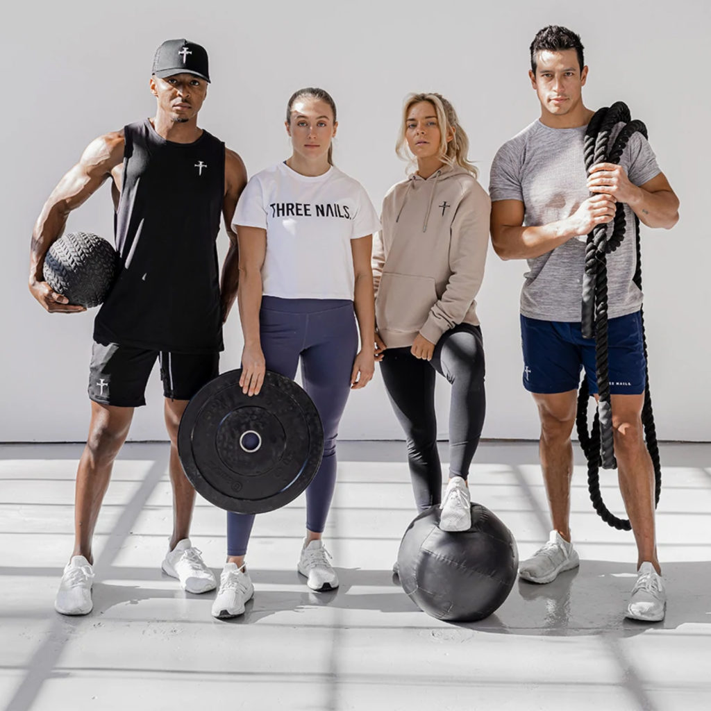 Athletic men and women wearing Three Nails apparel.