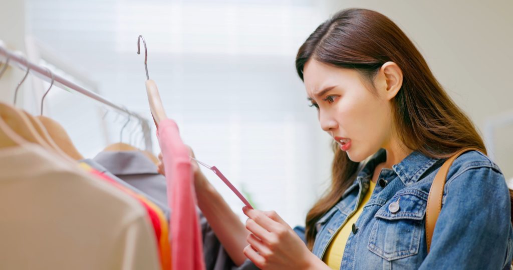 A shopper surprised by the increase in prices for apparel caused by supply chain issues