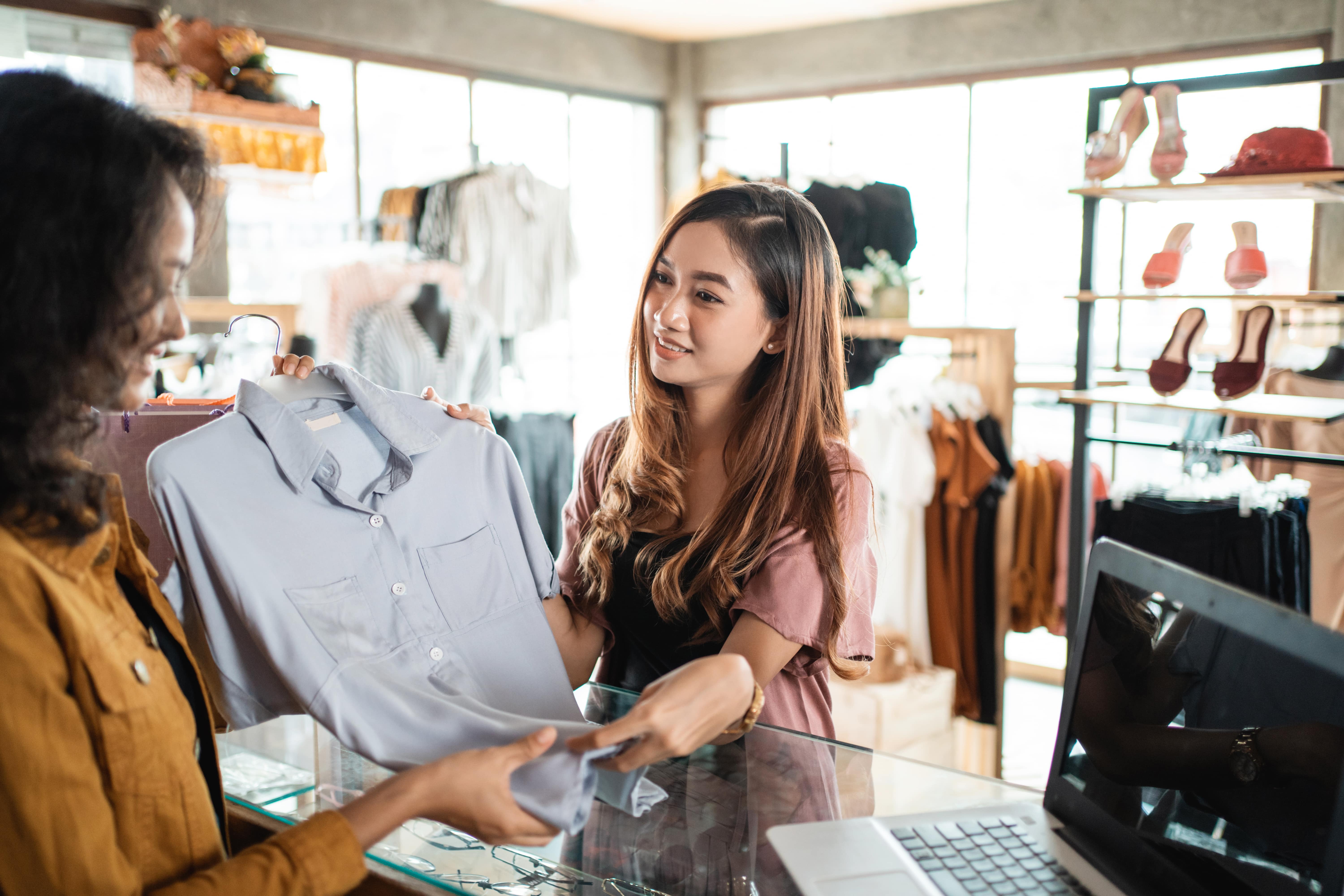 A shopper returning rented apparel to a store. Renting apparel is one of 2022's sustainable fashion trends