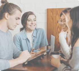 A group of smiling young professionals and partners having a meeting