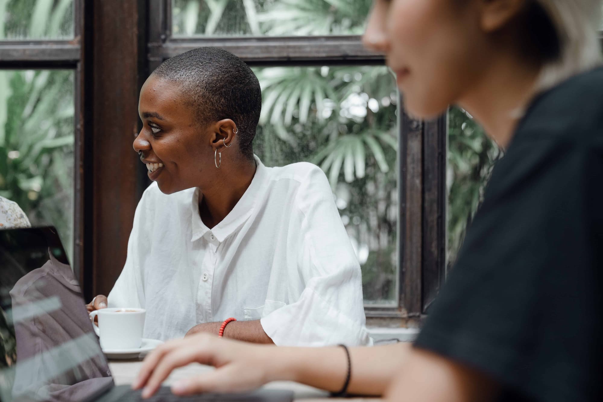 Woman smiling working with other people in tech
