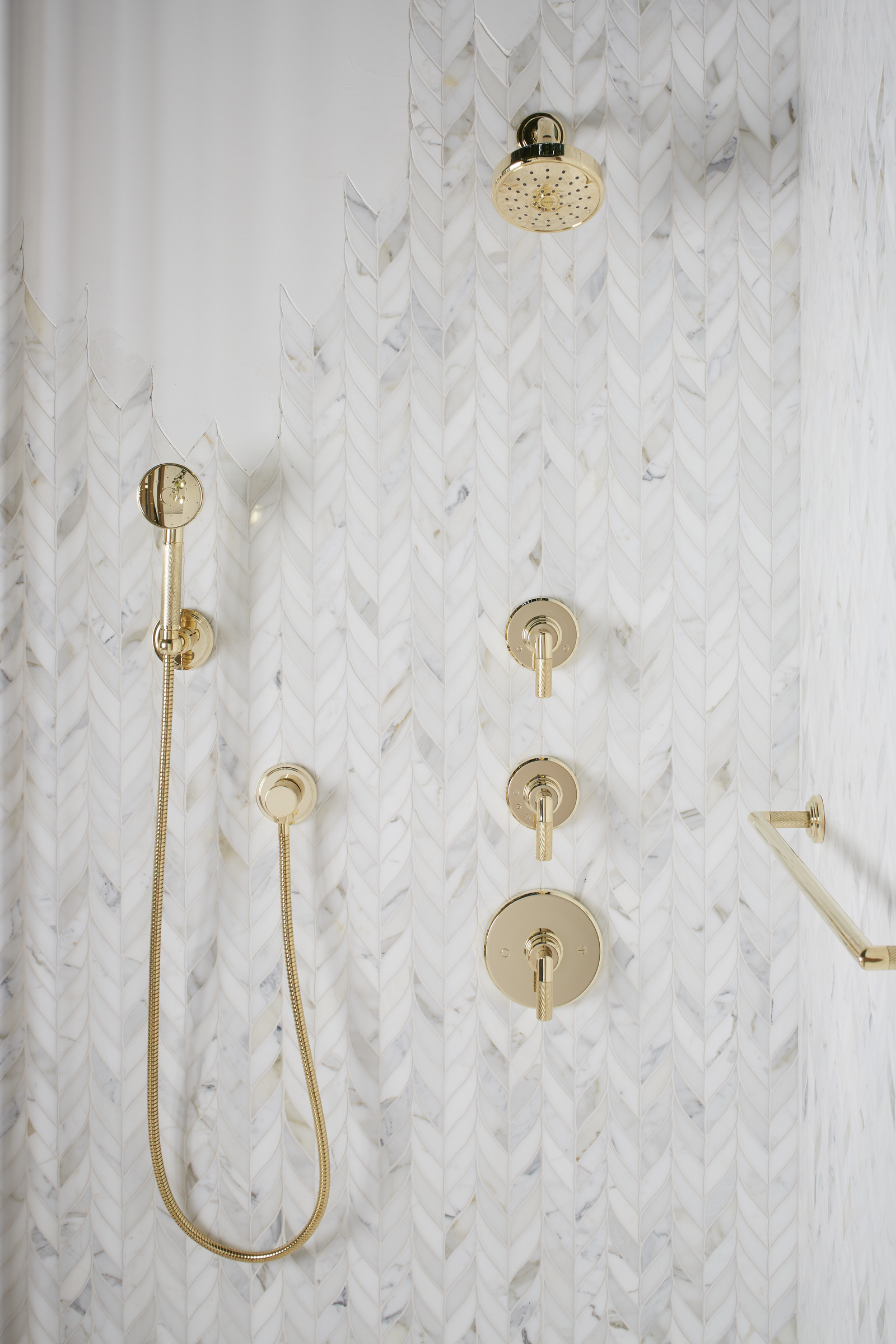 white shower with gold fixtures