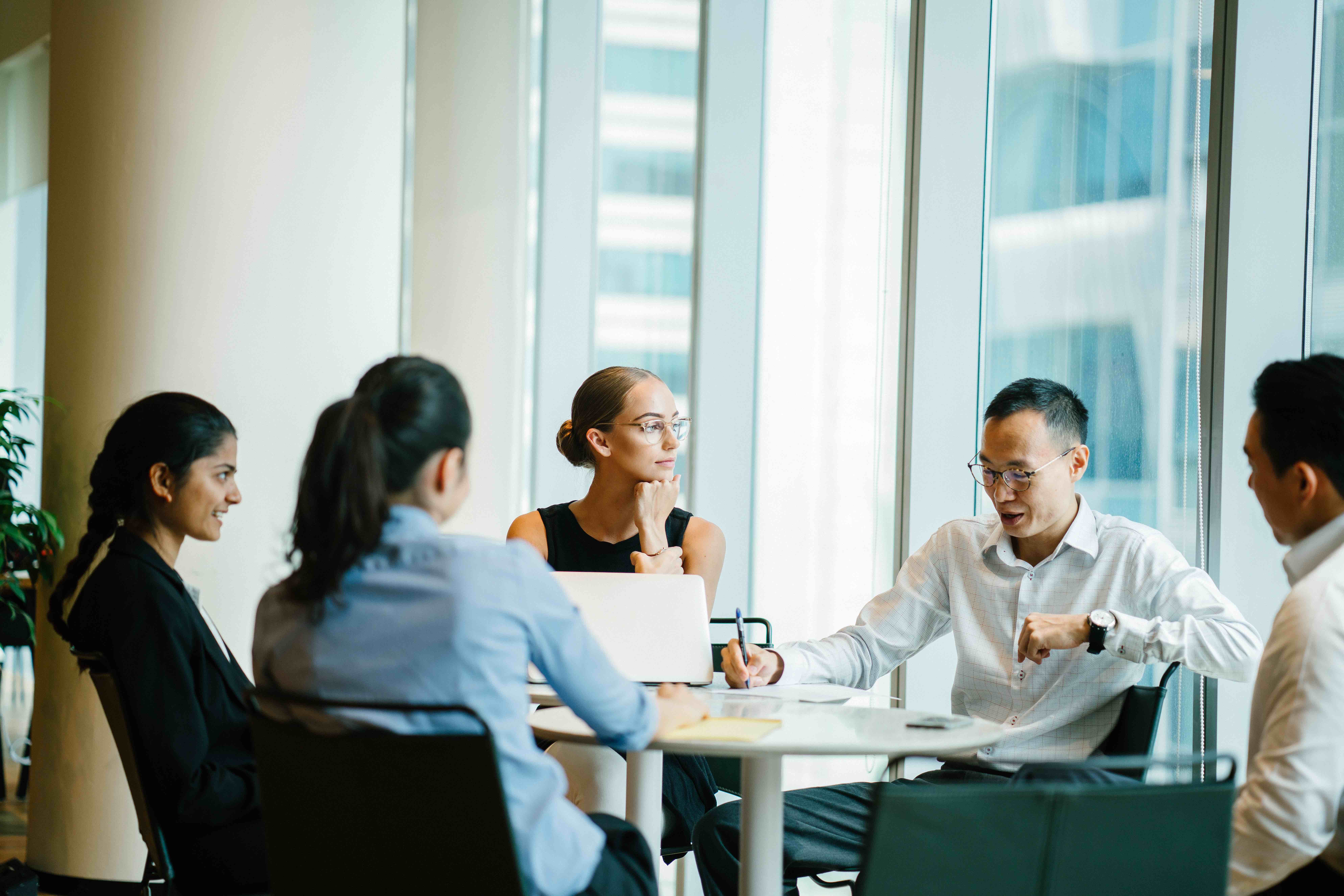 5 people in an office having a meeting