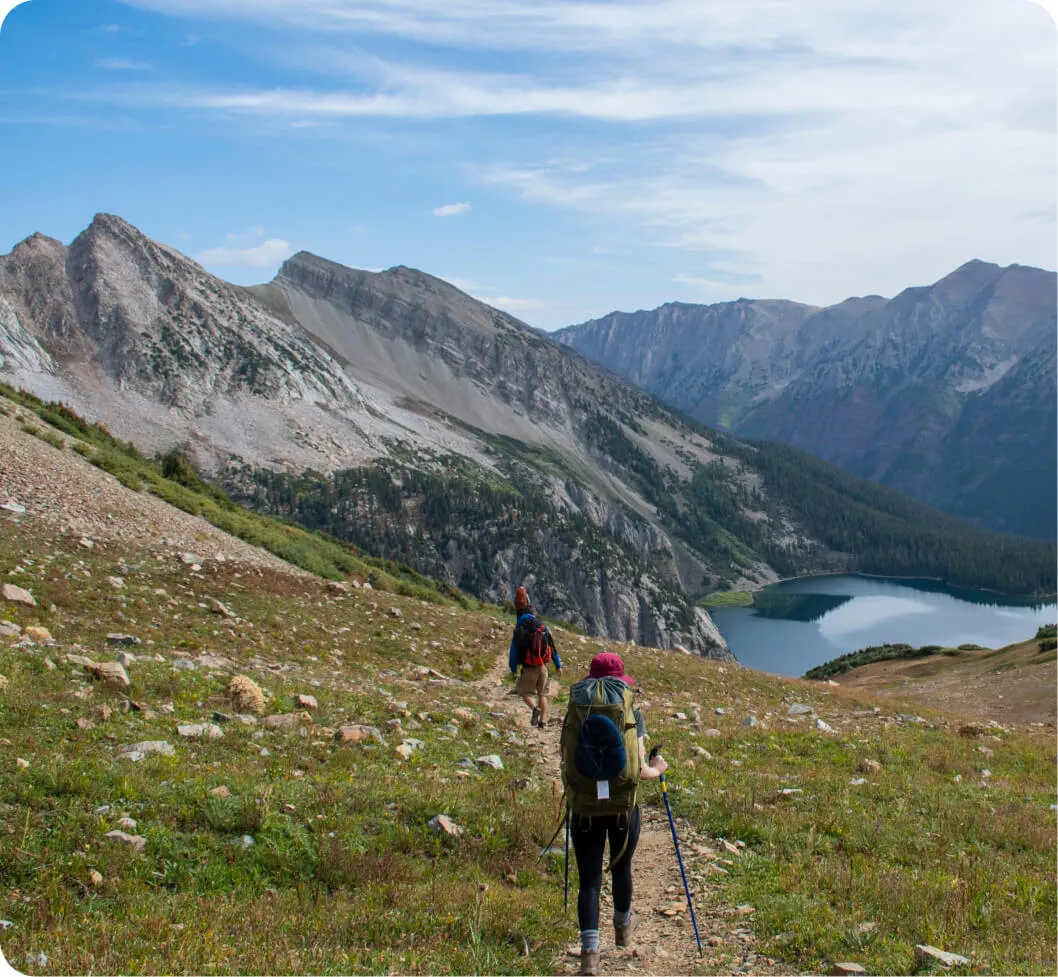 Three people taking a hike in beautiful mountains