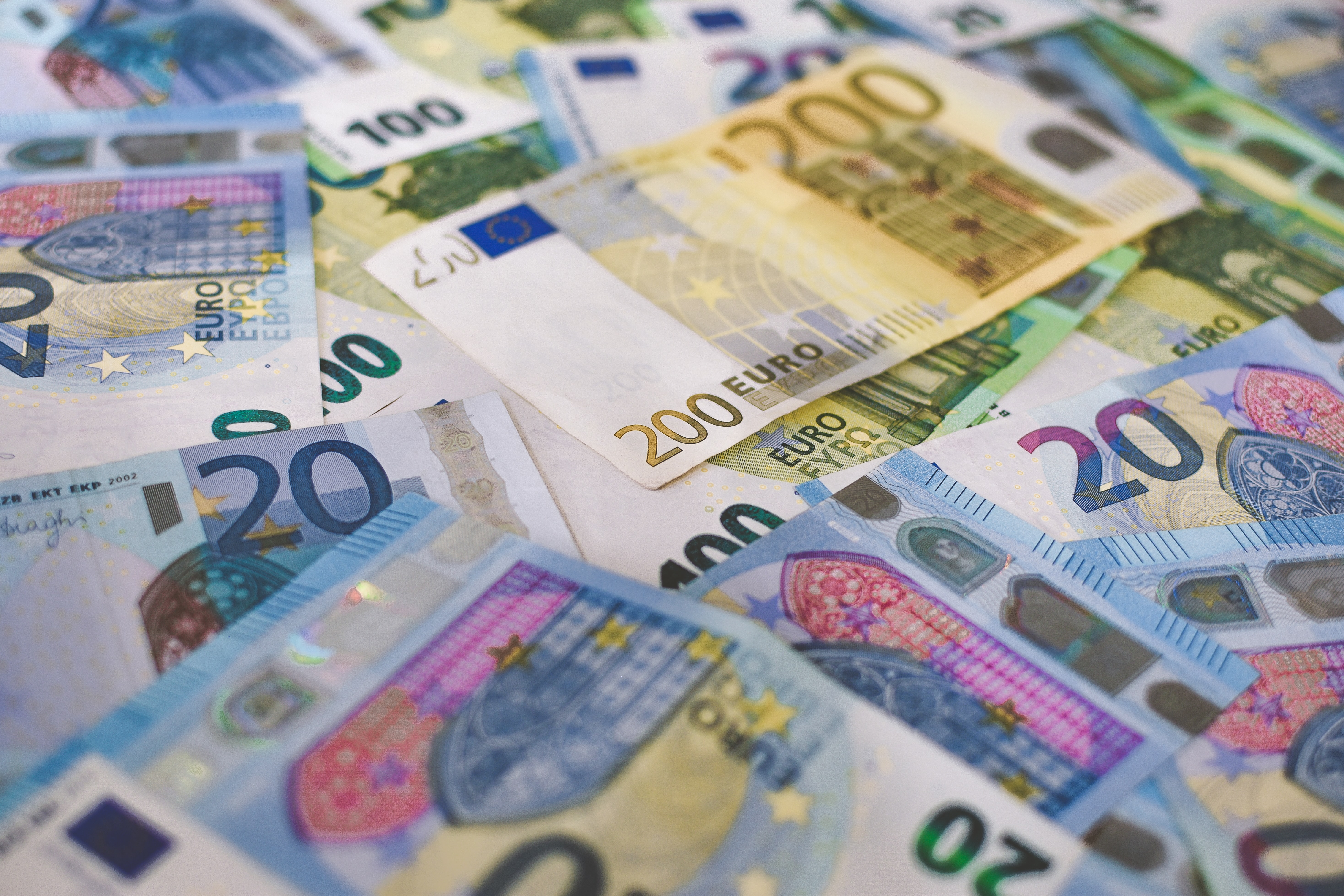 money of different denominations laid on a flat surface
