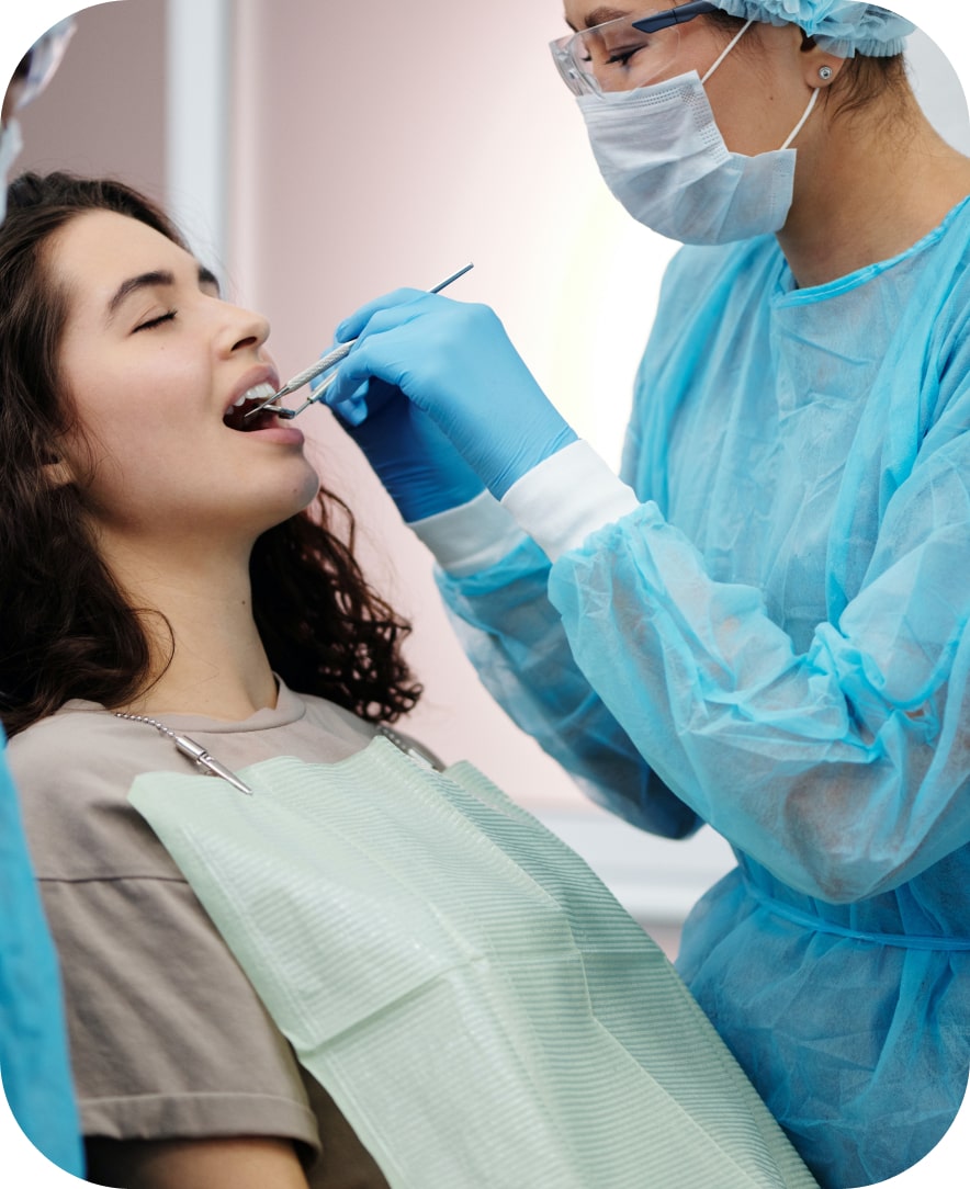 The hero image for a dentist - showing a doctor conducting a small operation.