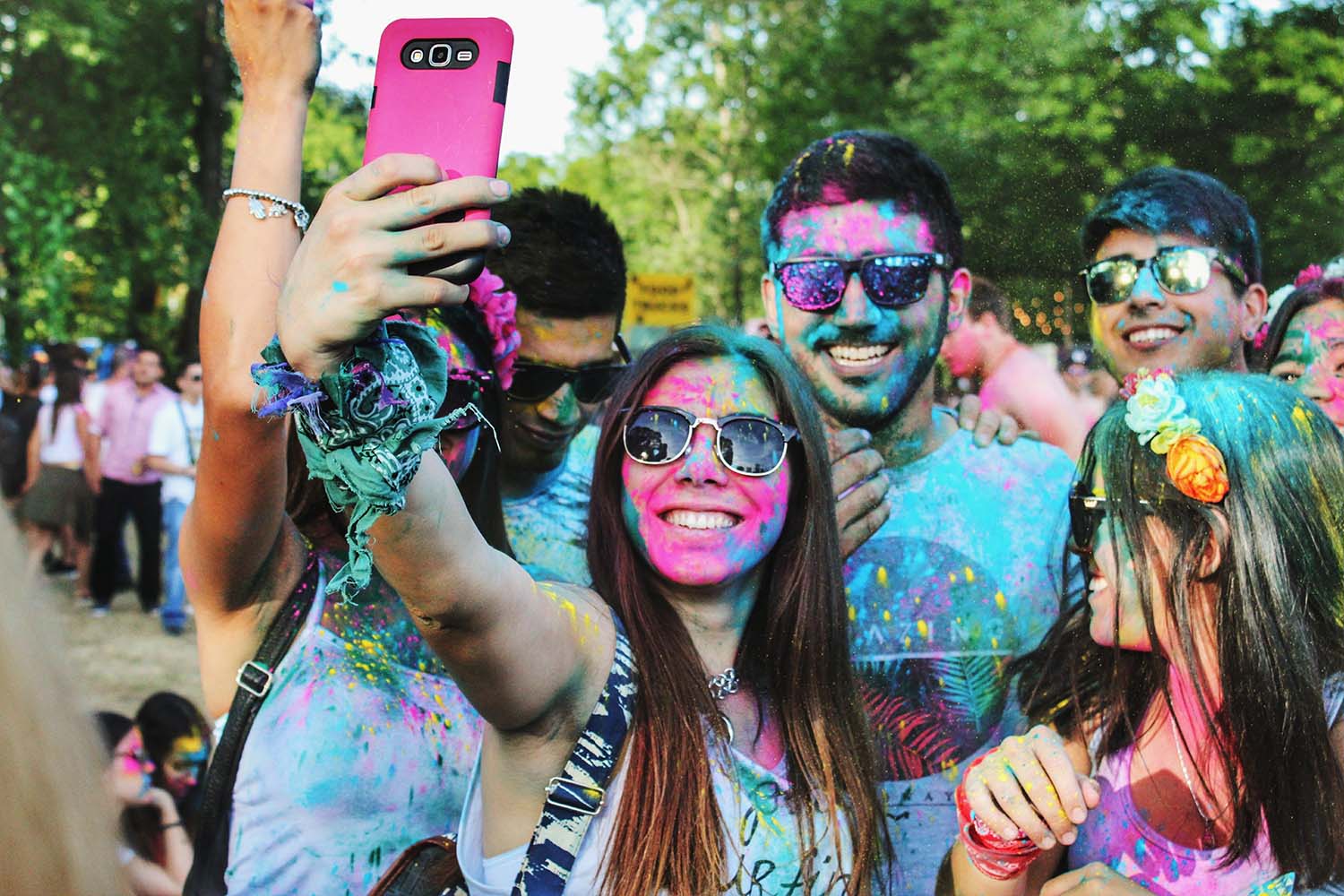 A group of people covered in paint taking photos