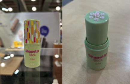 A green twist up stick (packaging component) dispensing formula in a geometric shape at the top