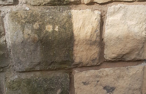 before and after preview of our pressure washing service on stone