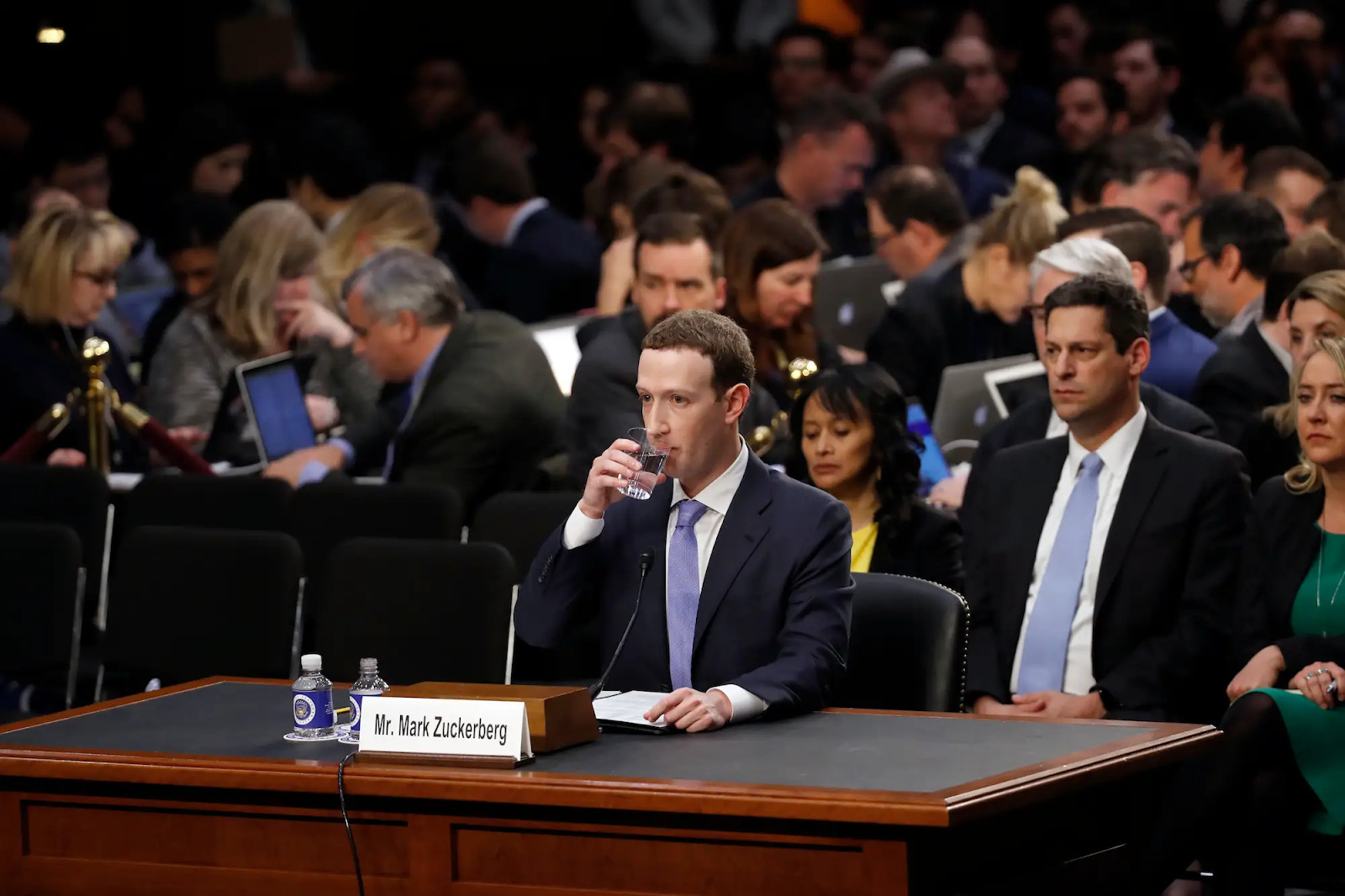 Image of Mark Zuckerberg in a conference drinking water