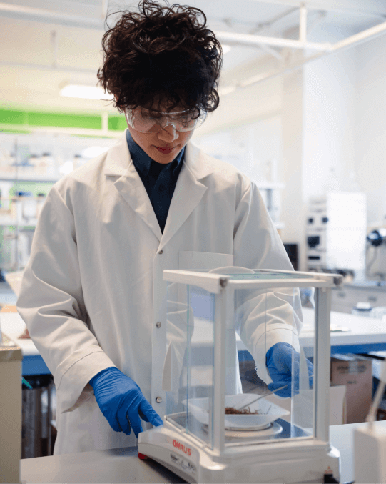 A person in a lab coat using medical apparatus
