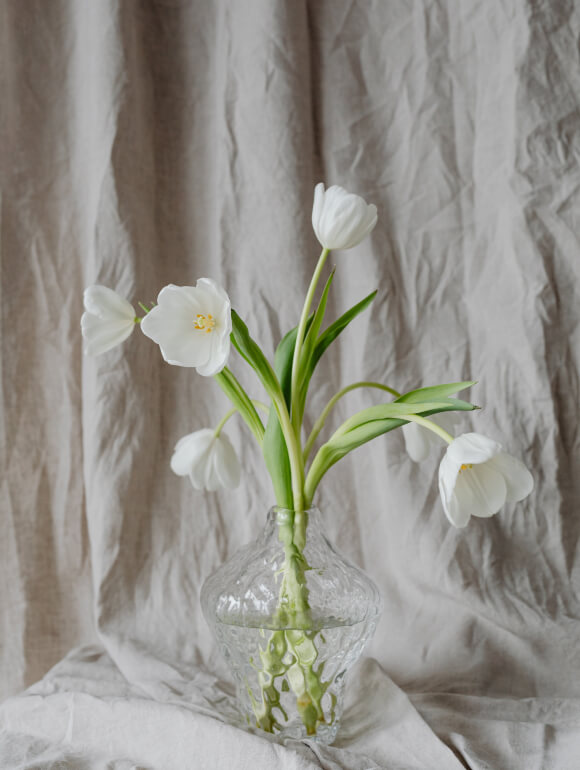 White tulips and linen fabric background