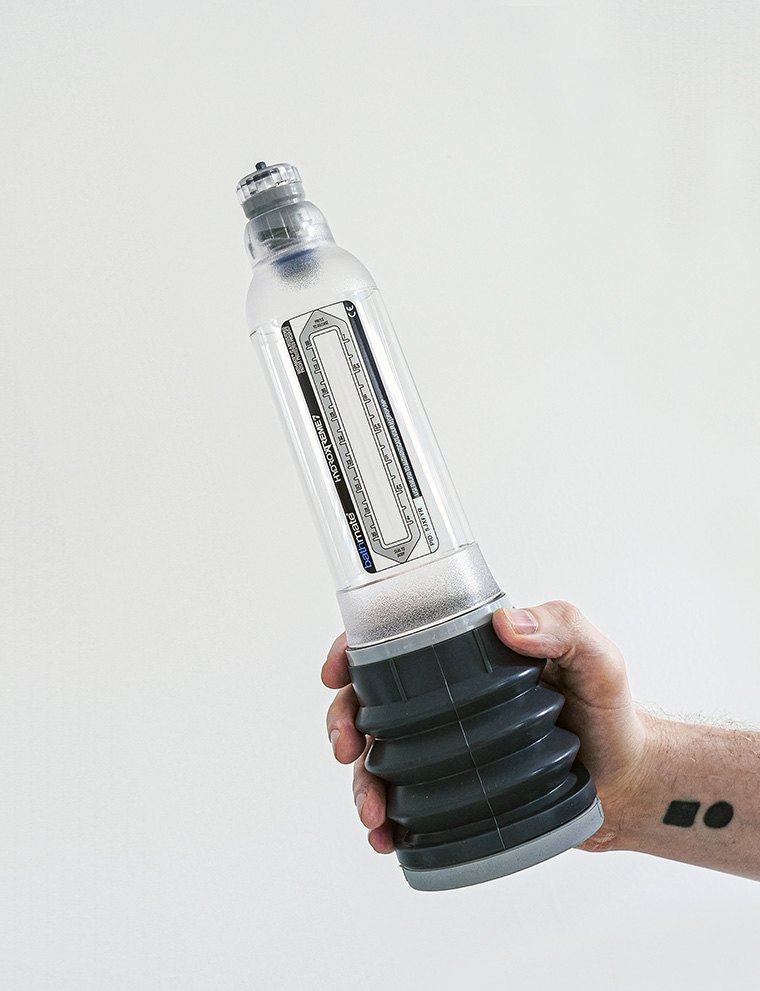 penis pump being held in hand