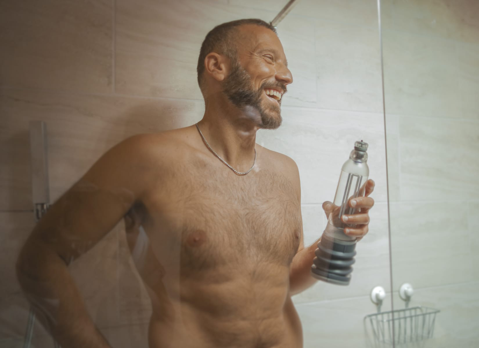 Man in shower holding hydro7 pump