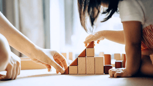 Dividend Investing Stocks Strategies Research - Capital Group on RFPnetworks - depicted by children building a pyramid with wooden blocks.