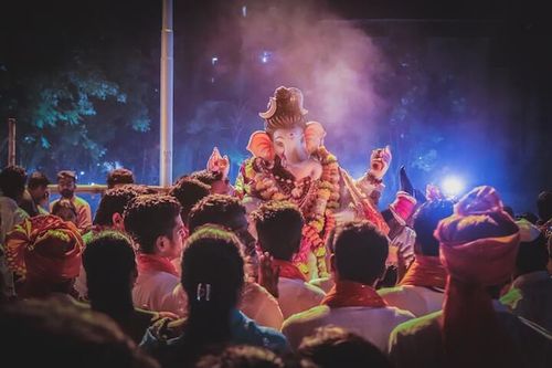 RFPnetworks India Stock Market Research depicted by cultural event with People Standing in Front of Ganesha Statue
