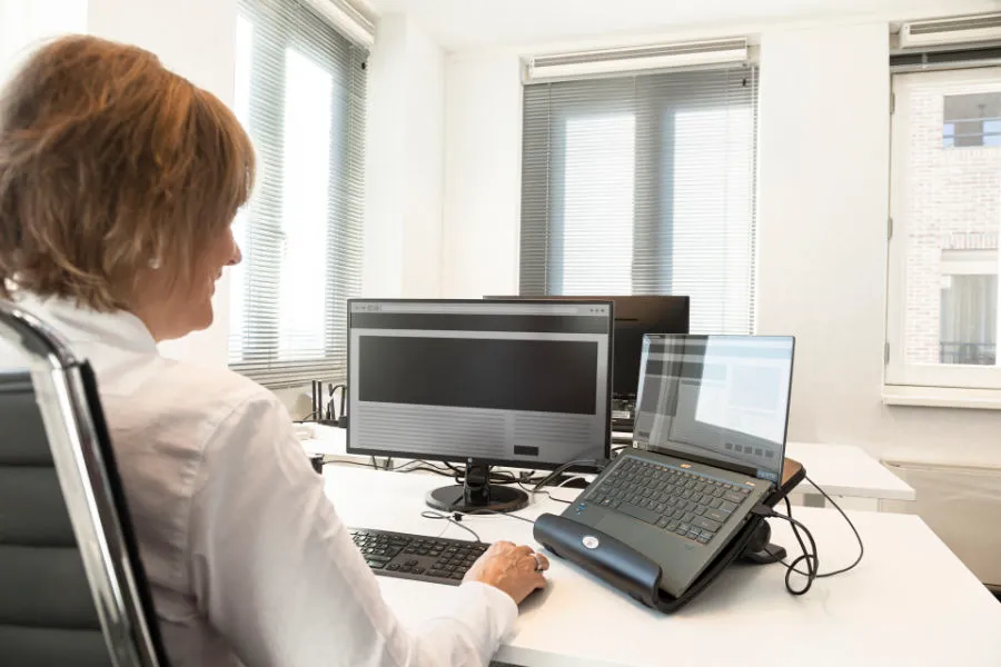 Astrid die werkt achter de computer in haar kantoor