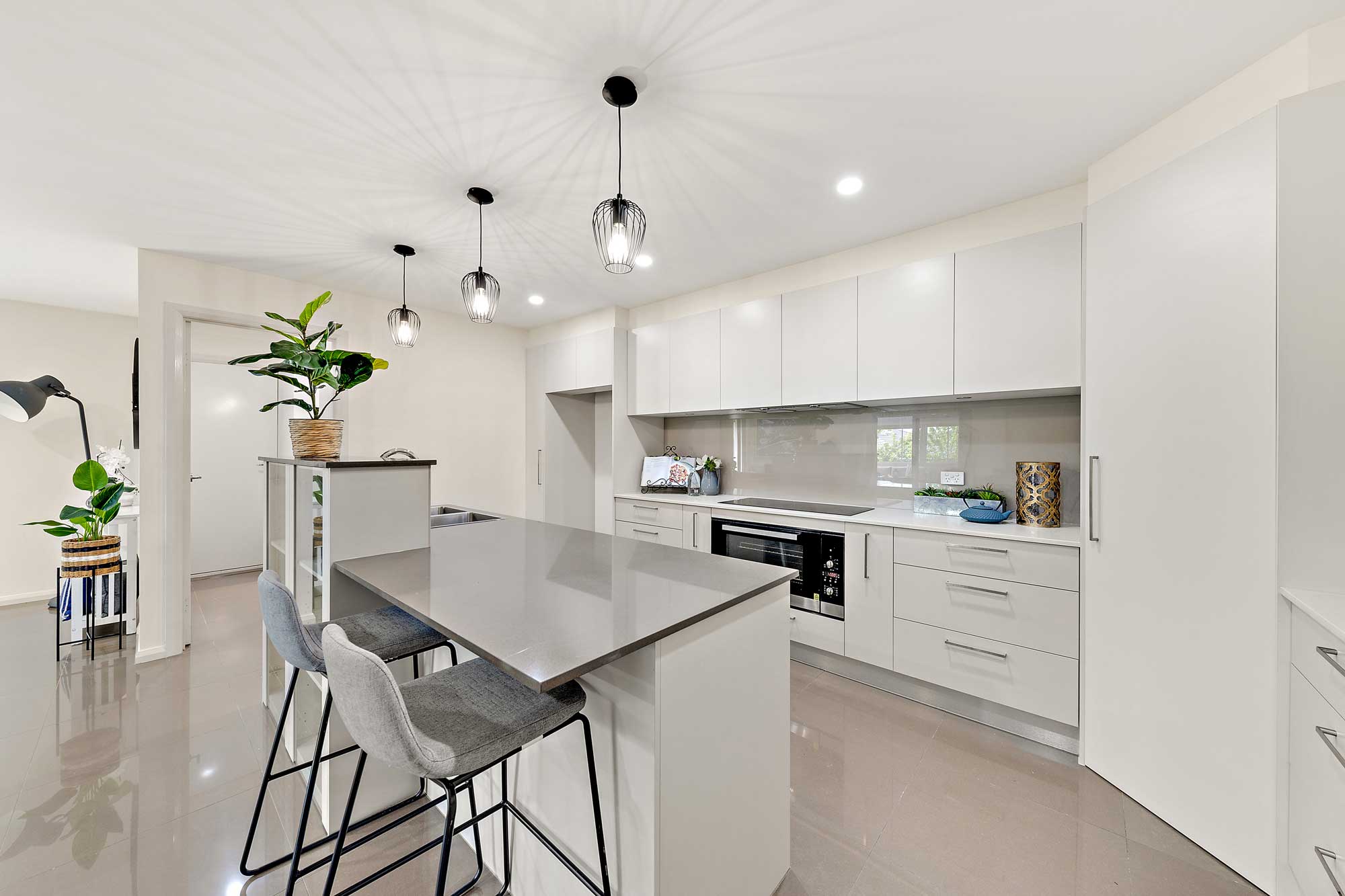 A beautiful modern kitchen with white walls and finishes.