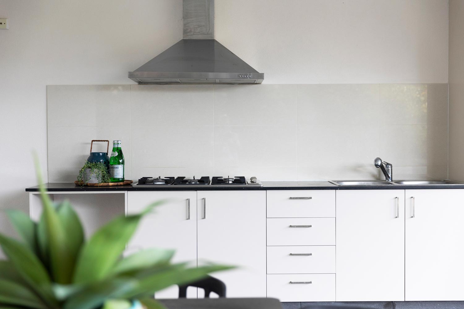 A closeup shot of an outdoor kitchen area with range hood.