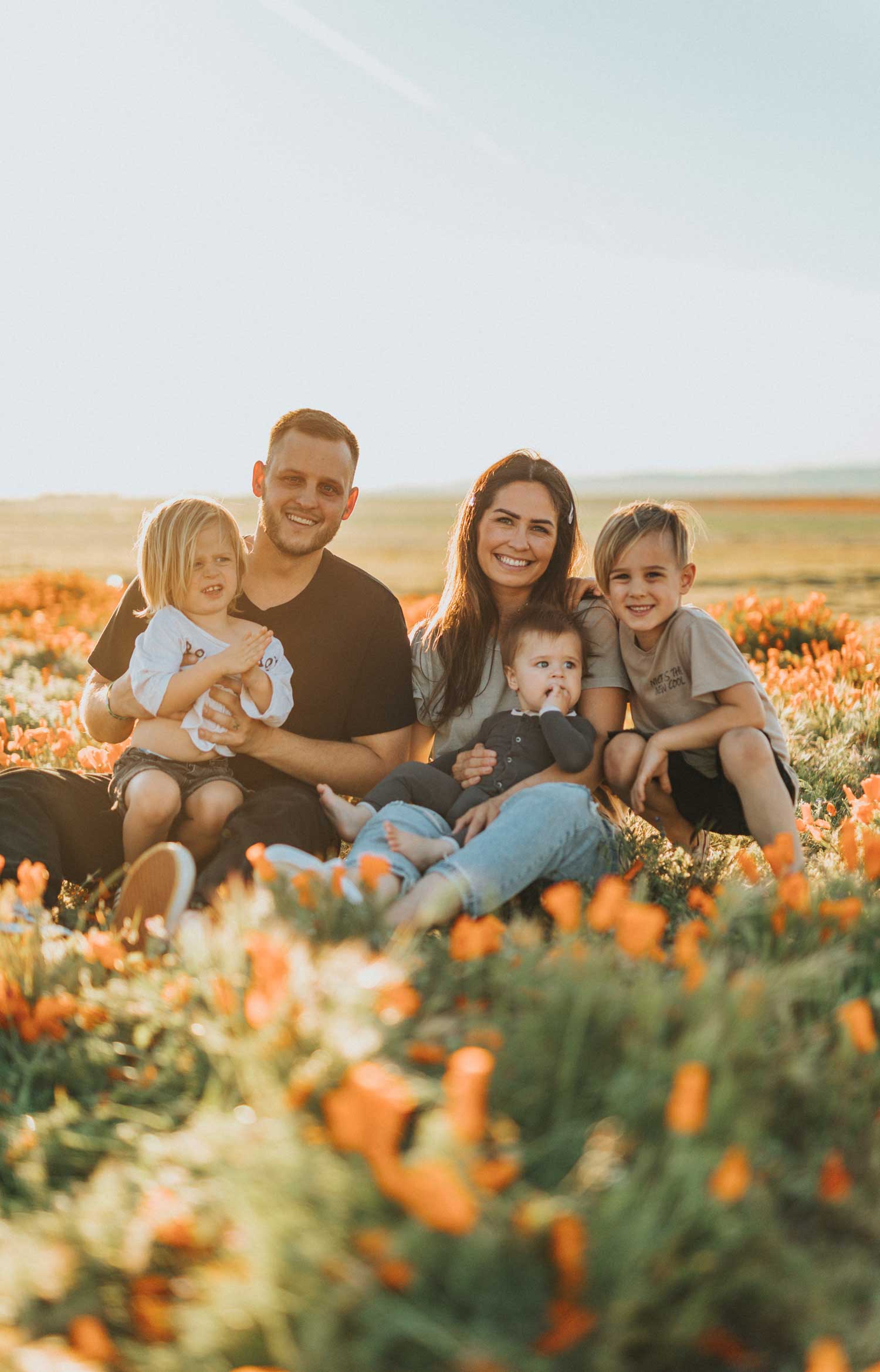 A smiling family of four, the couple and their two children.