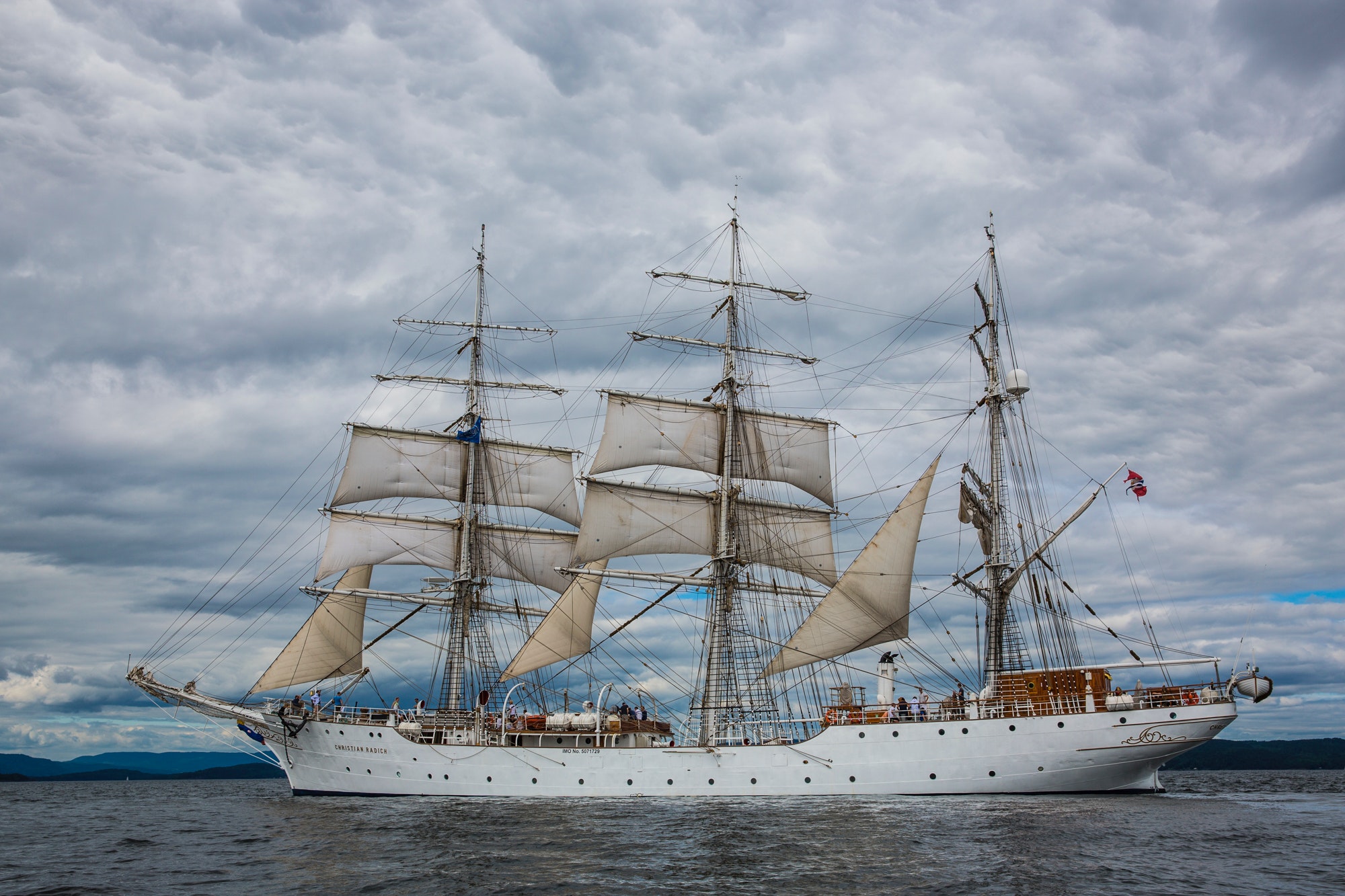 A sailing ship under a cloudy sky