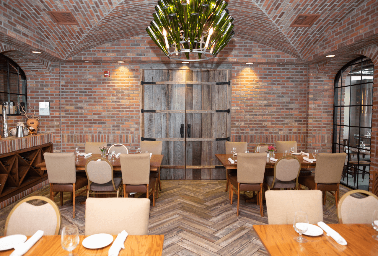 Coltivare restaurant private event space featuring brick walls and arches by Rocco Design + Build