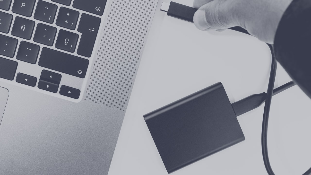 External drive being plugged into laptop