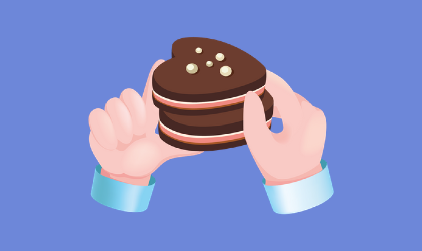 Two hands holding two heart-shaped chocolate cookies