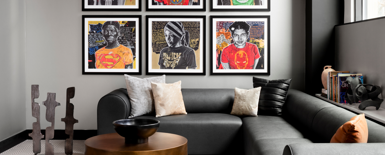 sofa with cushions on it and painting on the walls
