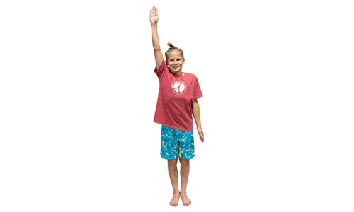 A young boy gymnast giving a salute