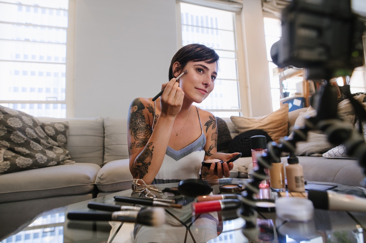 Women filming her self putting on a makeup