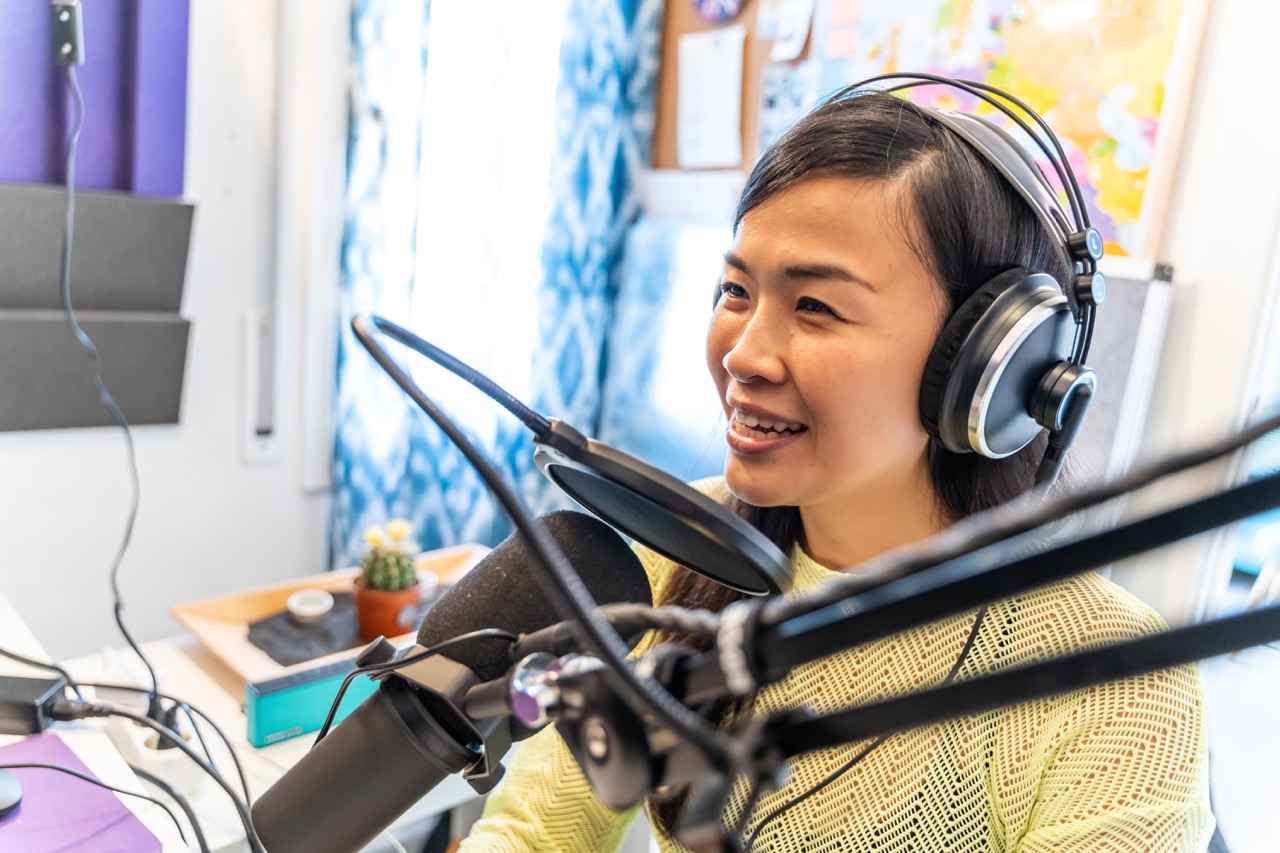 Women talking to a microphone in a studio