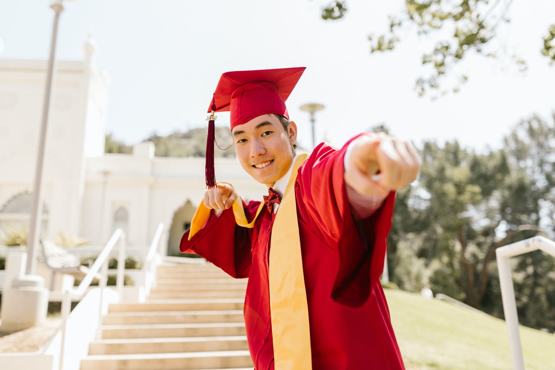 woman in red academic dress smiling