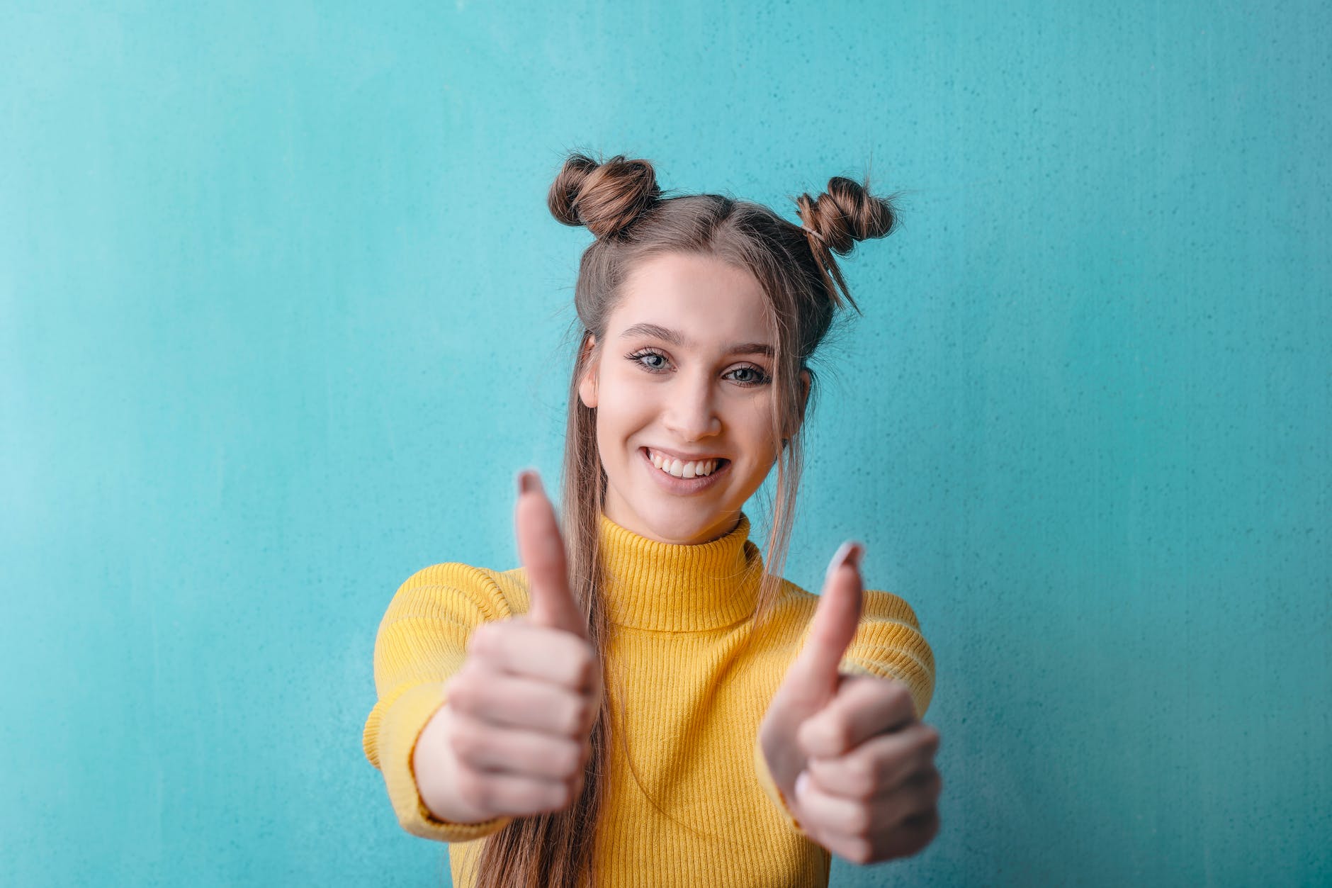 woman in yellow turtleneck sweater smiling