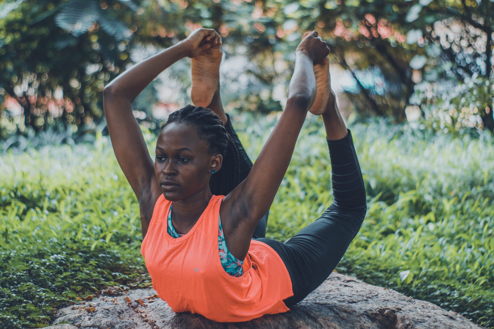 woman doing yoga on rock