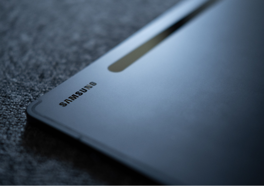Dark Close up of the Samsung logo on a black Galaxy tablet