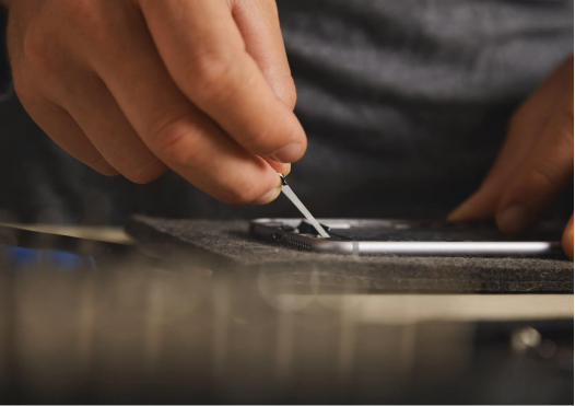 A close up of a person fixing the inside of a cell phone