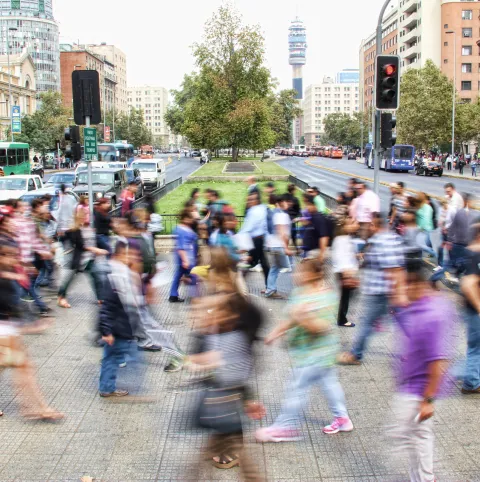 People crossing a large avenue.