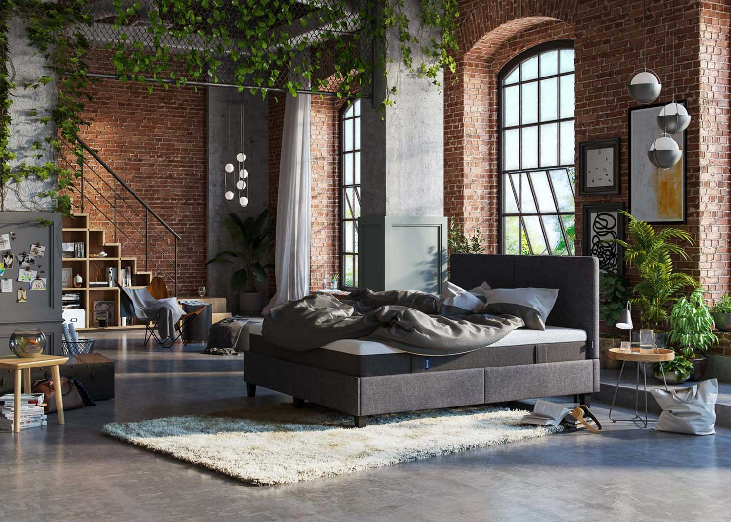 Gemütlicher Loft mit Backsteinwänden und einem grauen Bett von Emma
