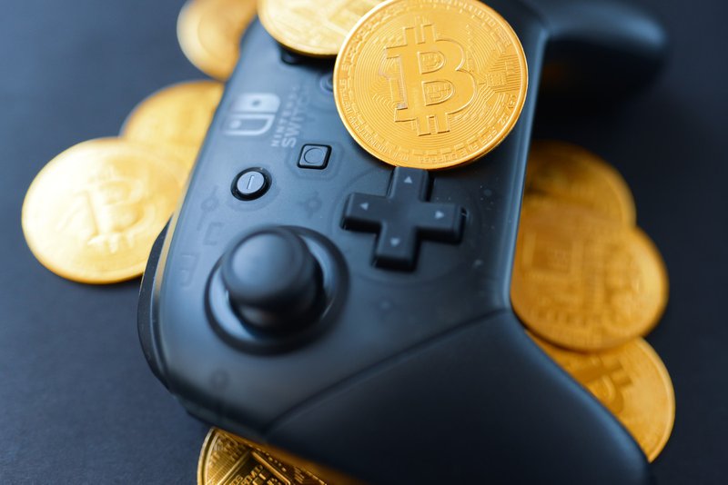 Bitcoin coins on a gaming controller