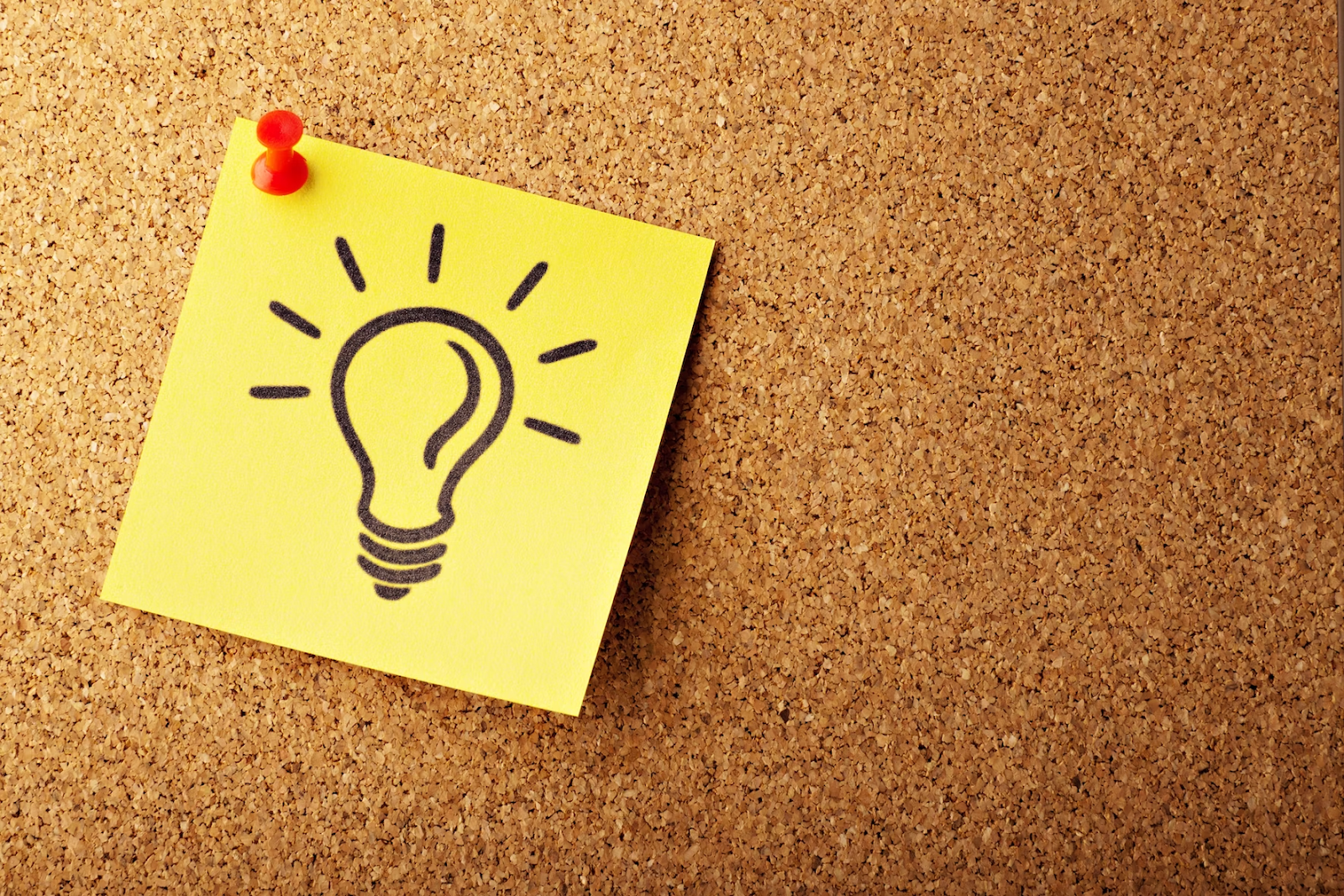 Brainstorming lightbulb on a sticky note.