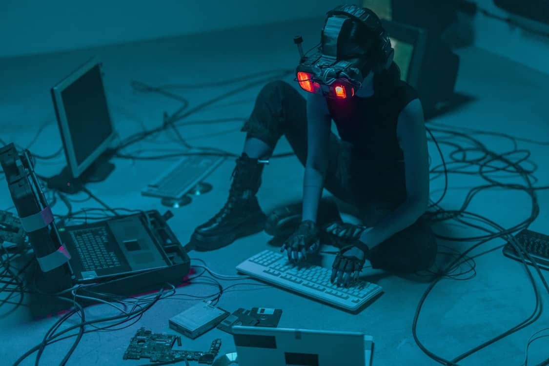 Cyberpunk photo of a person sorrounded by tech.