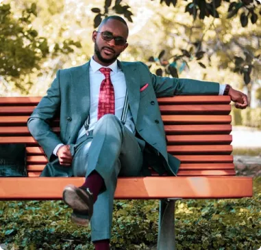 a man seating in an outdoor bench
