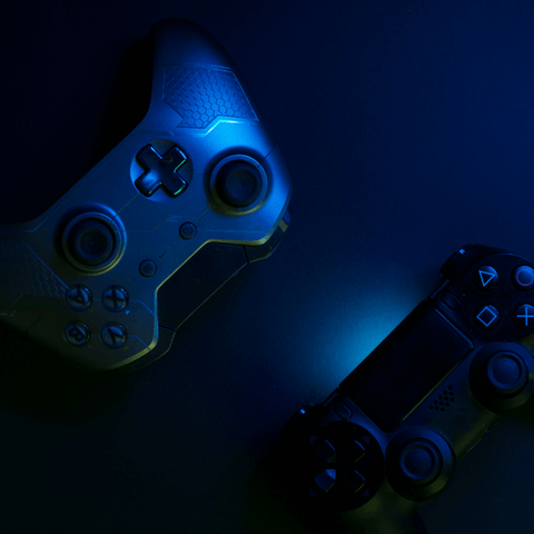  Esports Teams Gaming controllers on dark background