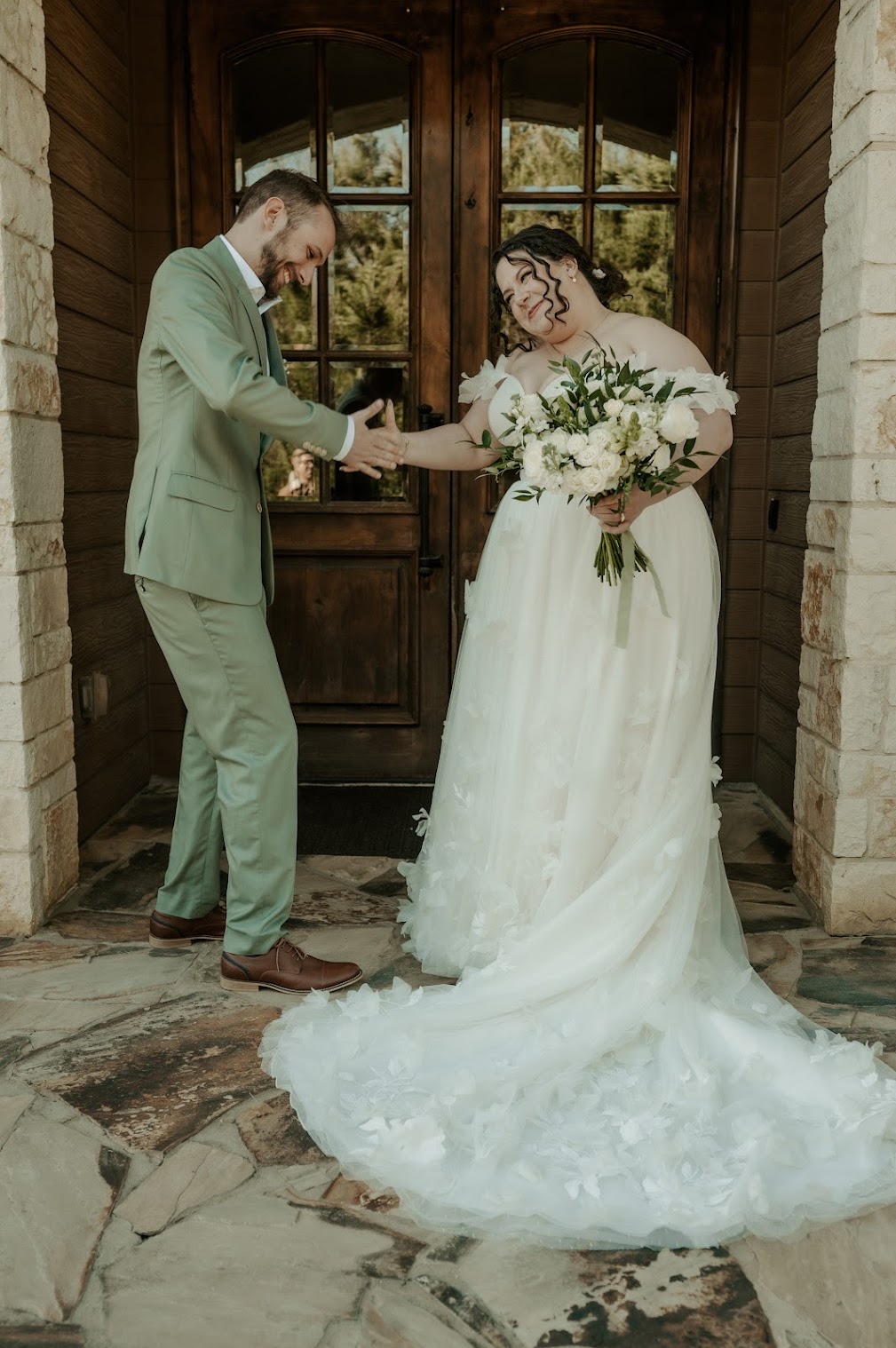 Bride and groom pose for a photo on wedding day