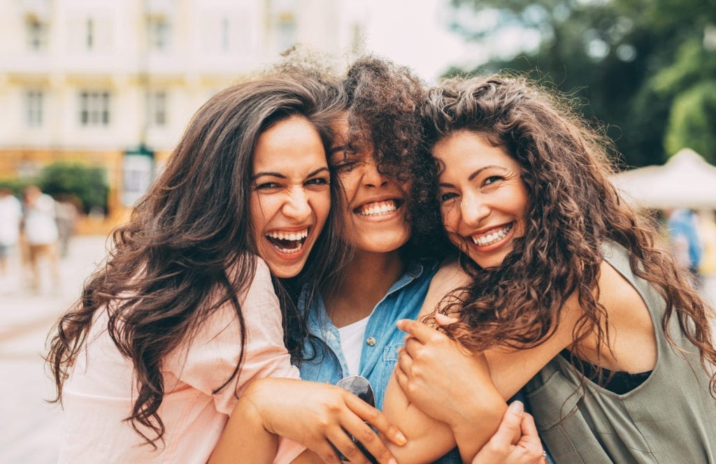 happy females embrace