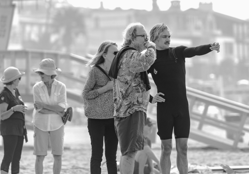 Three people looking at the ocean.