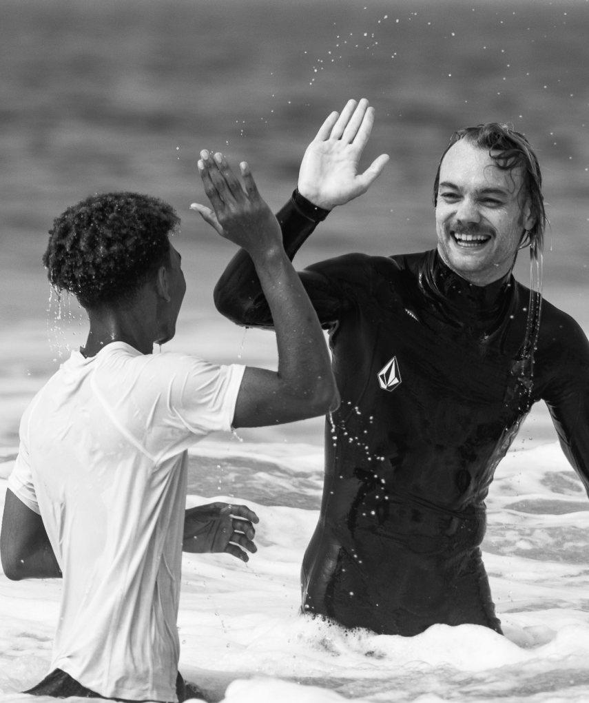 Two people high-fiving each other.