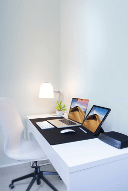 a laptop lying on a big table