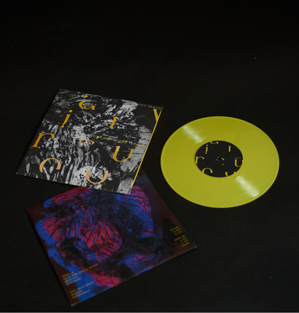 Cropped image of music poster, dark red background with a clay realistic heart in both blue and red with yellow type in vinyl form, with a yellow vinyl